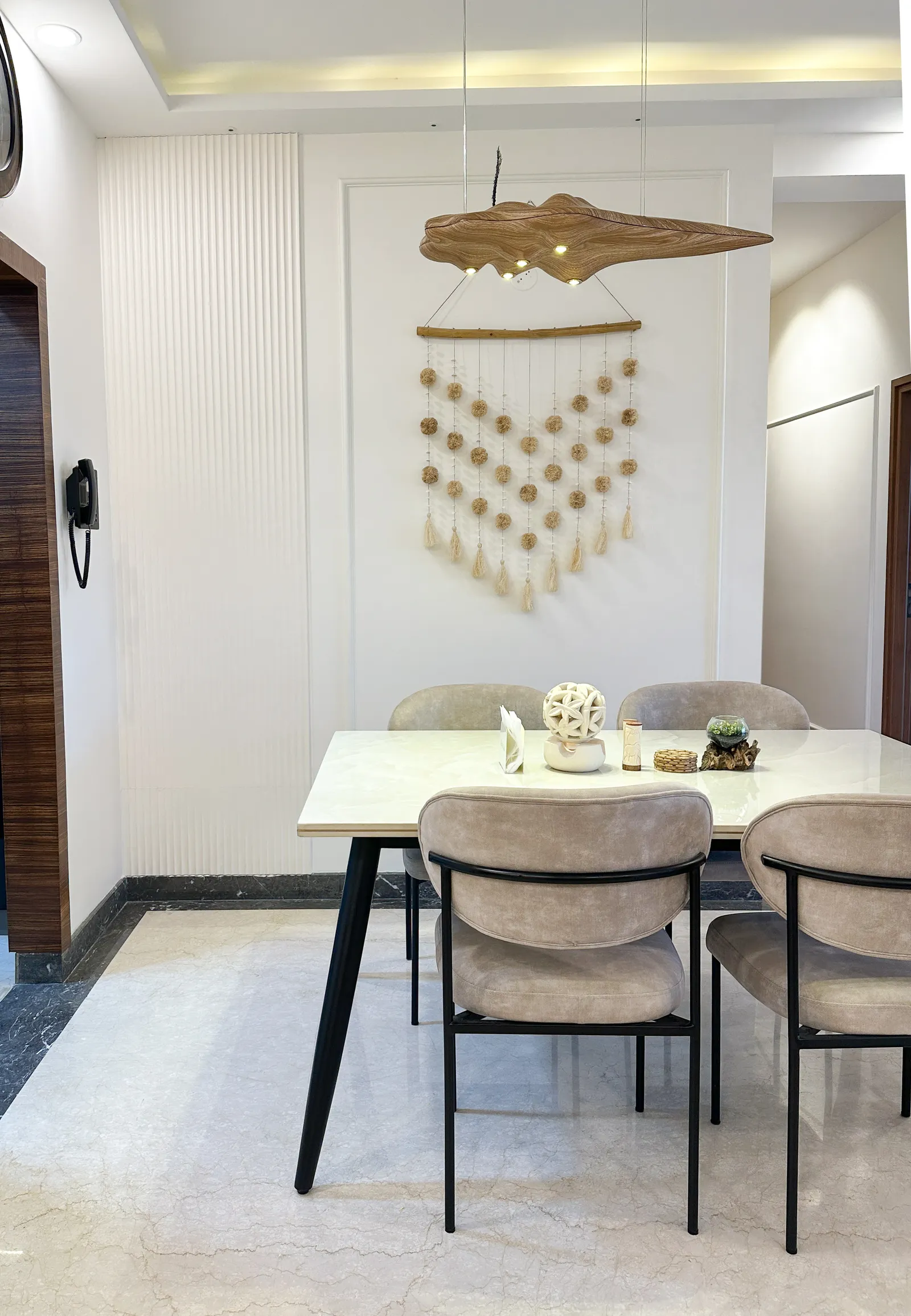 Dining table with wall hanging and timber leaf decor — Somani's Residence